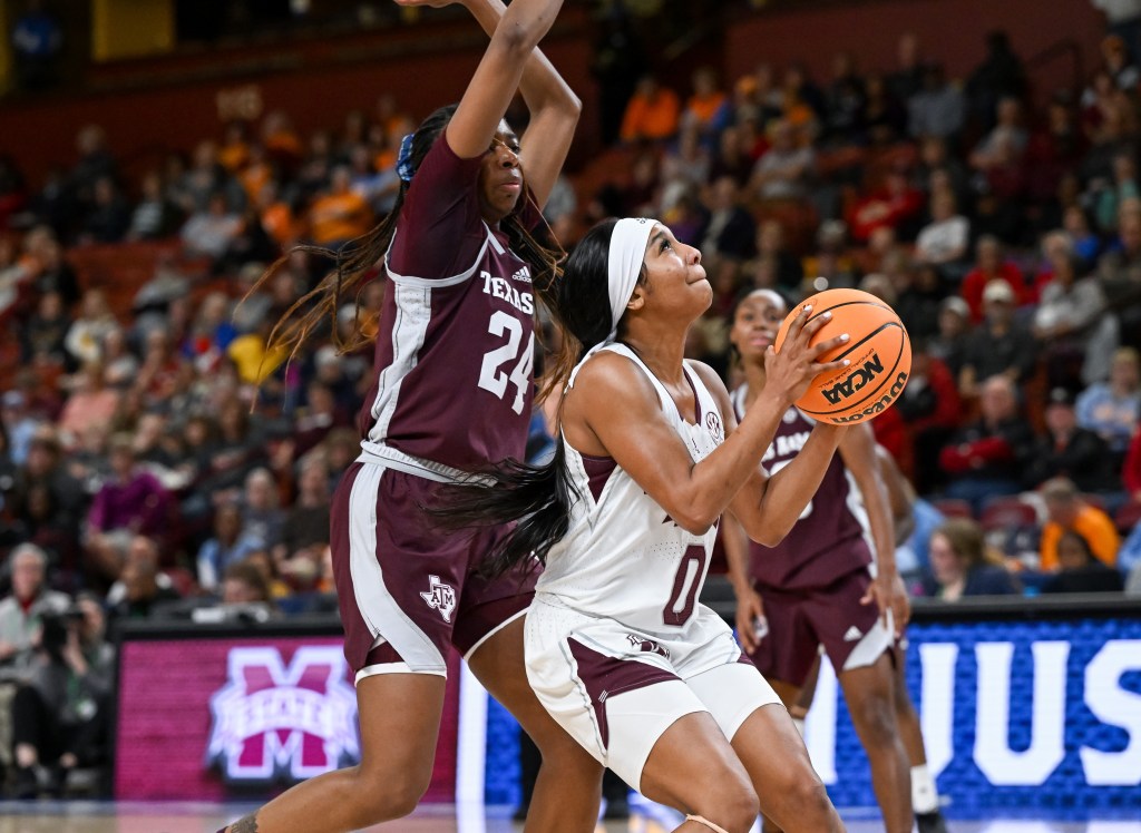 Mississippi State's Anastasia Hayes readies to shoot with a defender on her back.