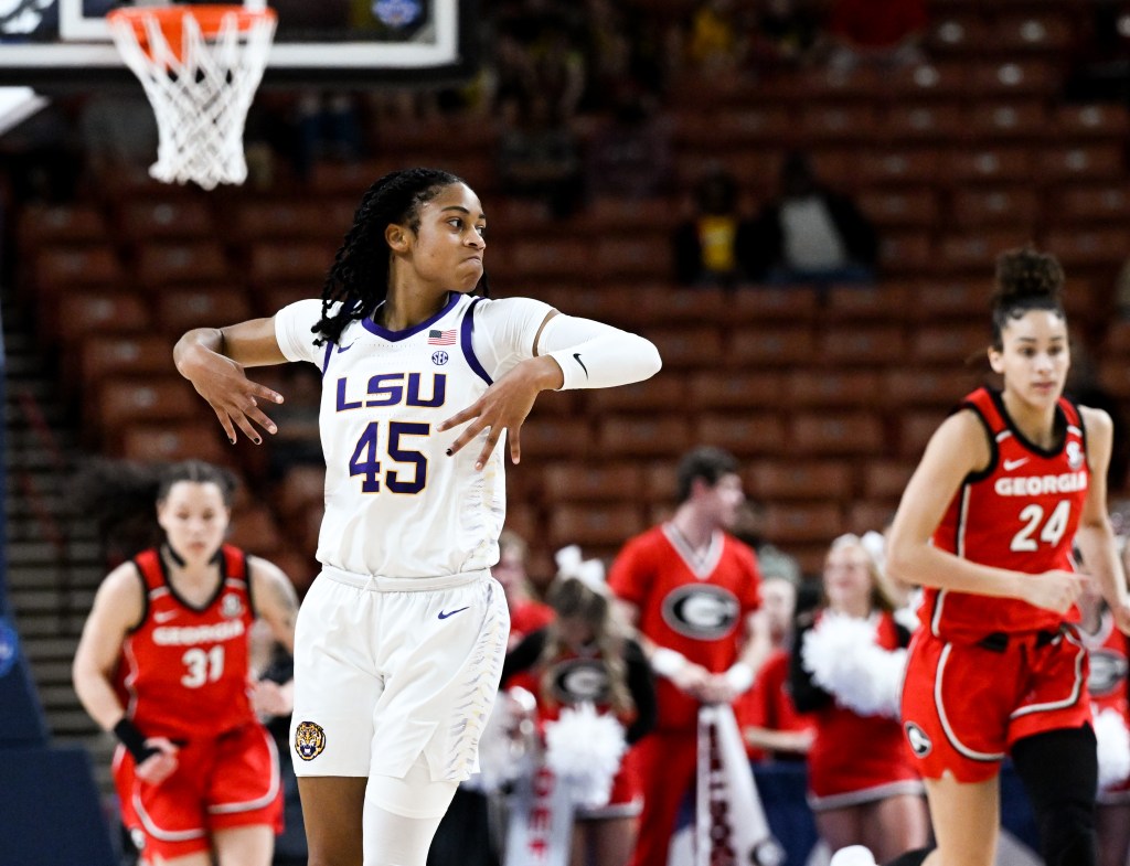 LSU's Alexis Morris flashes four fingers on each hand, her elbows extended to the side and hands pointing down.