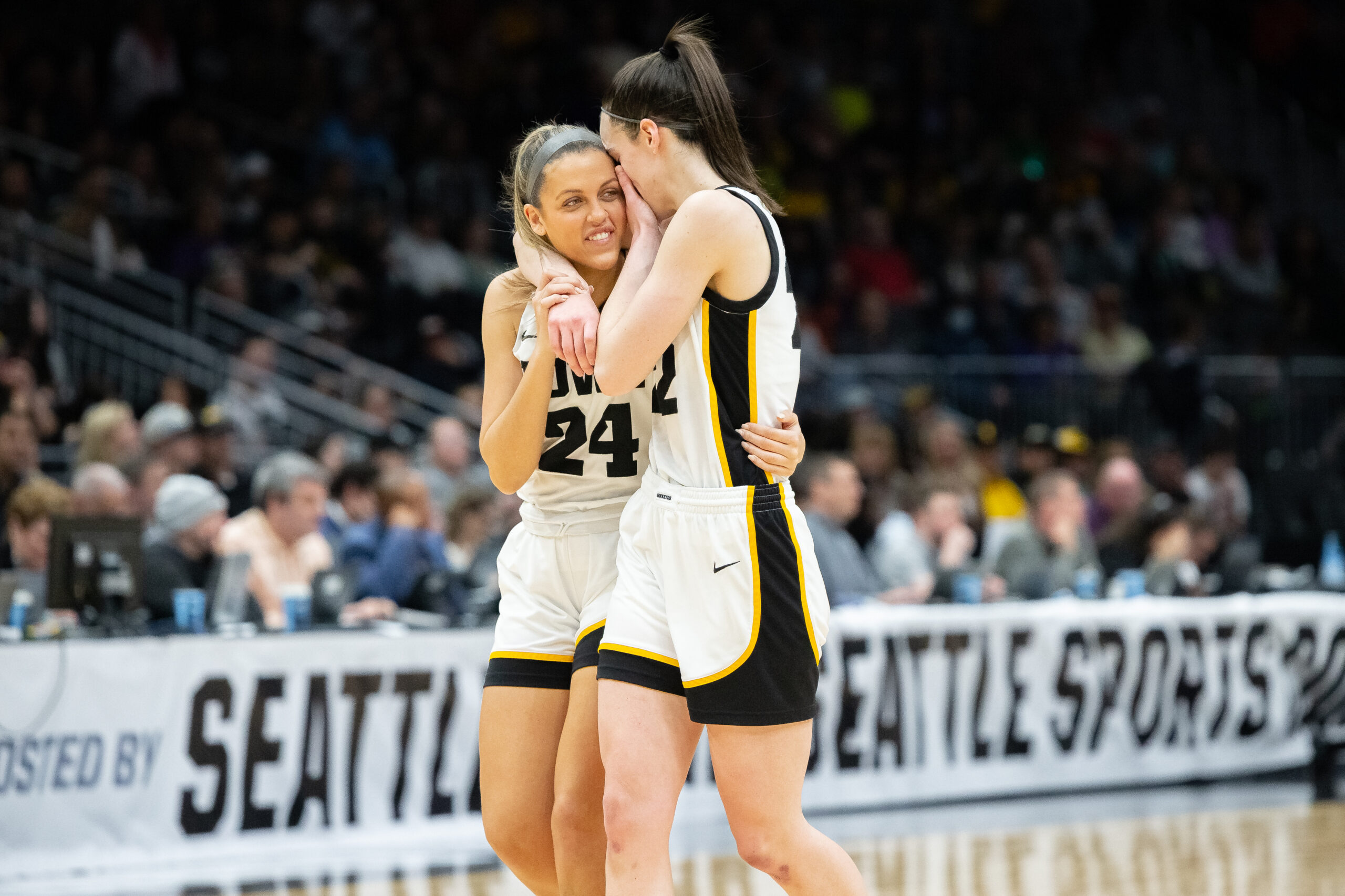 Gabbie Marshall and Caitlin Clark chat in Iowa and Louisville's matchup in the Elite Eight round of the NCAA Women’s Basketball Tournament, March 26, 2023, at Climate Pledge Arena in Seattle, Wash. Photo Credit: Lydia Ely/The Next
