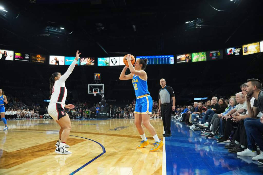 UCLA's Gina Conti attempts a 3-pointer as a Washington State defender gets a hand up.