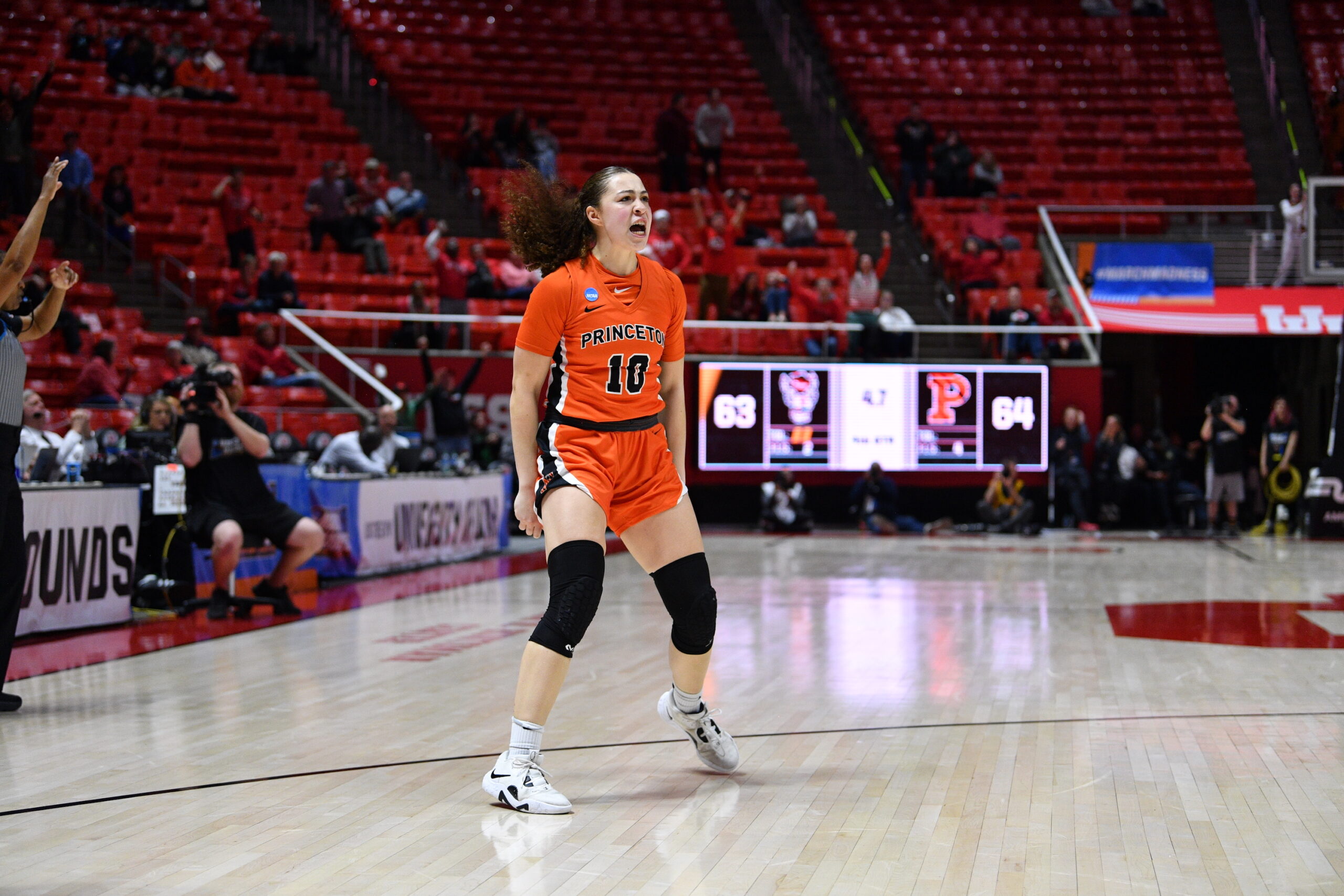 Princeton guard Grace Stone is pictured all alone after hitting the game-winning shot, her hands at her sides and her mouth open.