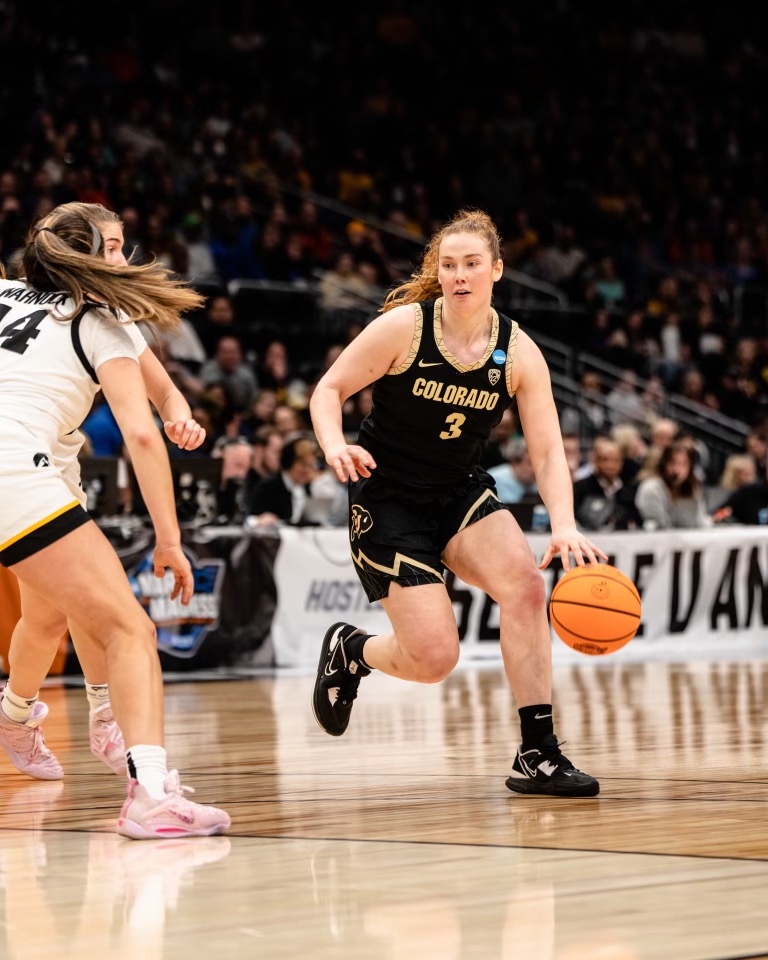 Colorado guard Frida Formann dribbles with her left hand, looking to turn the corner against an Iowa defender.