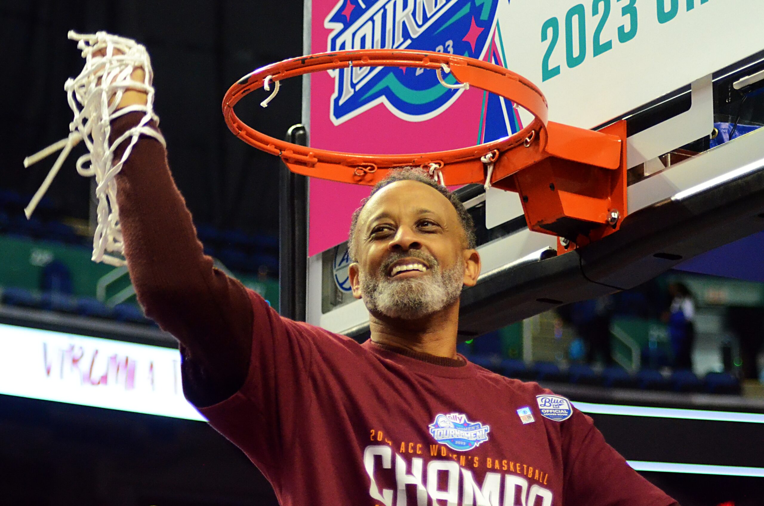 Kenny Brooks hoists up the net he cut down after winning the ACC Tournament championship on March 5, 2023 in Greensboro, N.C. Virginia Tech faces LSU Friday night in the 2023 Women's Final Four. (Mitchell Northam / The Next)