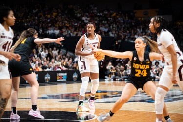 South Carolina forward Aliyah Boston holds the ball near the top of the key and surveys her options.