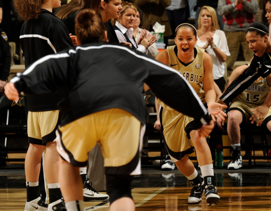 Vanderbilt point guard Jasmine Lister low-fives her teammates and smiles as she runs onto the court during pregame introductions.
