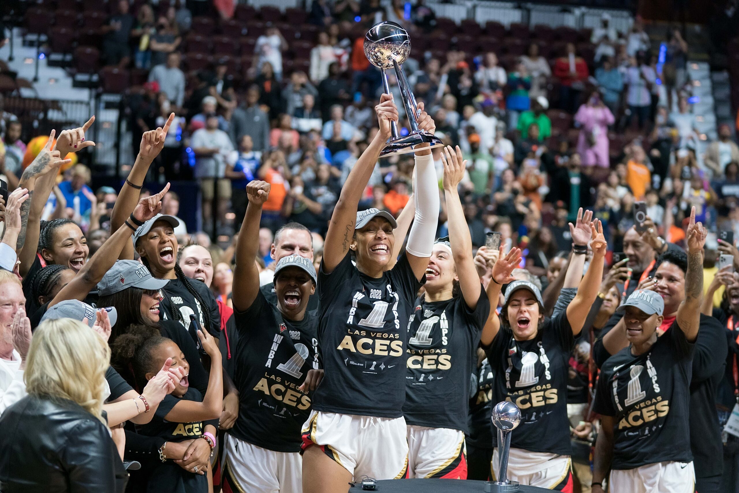 Las Vegas Aces center A'ja Wilson (22) raises the trophy while surrounded by her teammates after winning the 2022 WNBA Championship series between the Las Vegas Aces and the Connecticut Sun at Mohegan Sun Arena, Uncasville, Connecticut