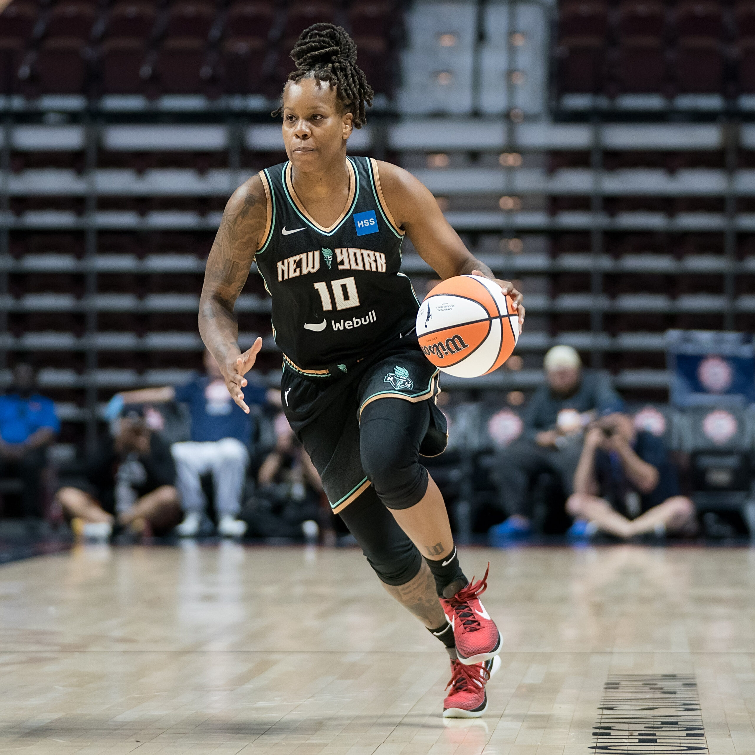 Epiphanny Prince dribbles the basketball in a black New York Liberty uniform