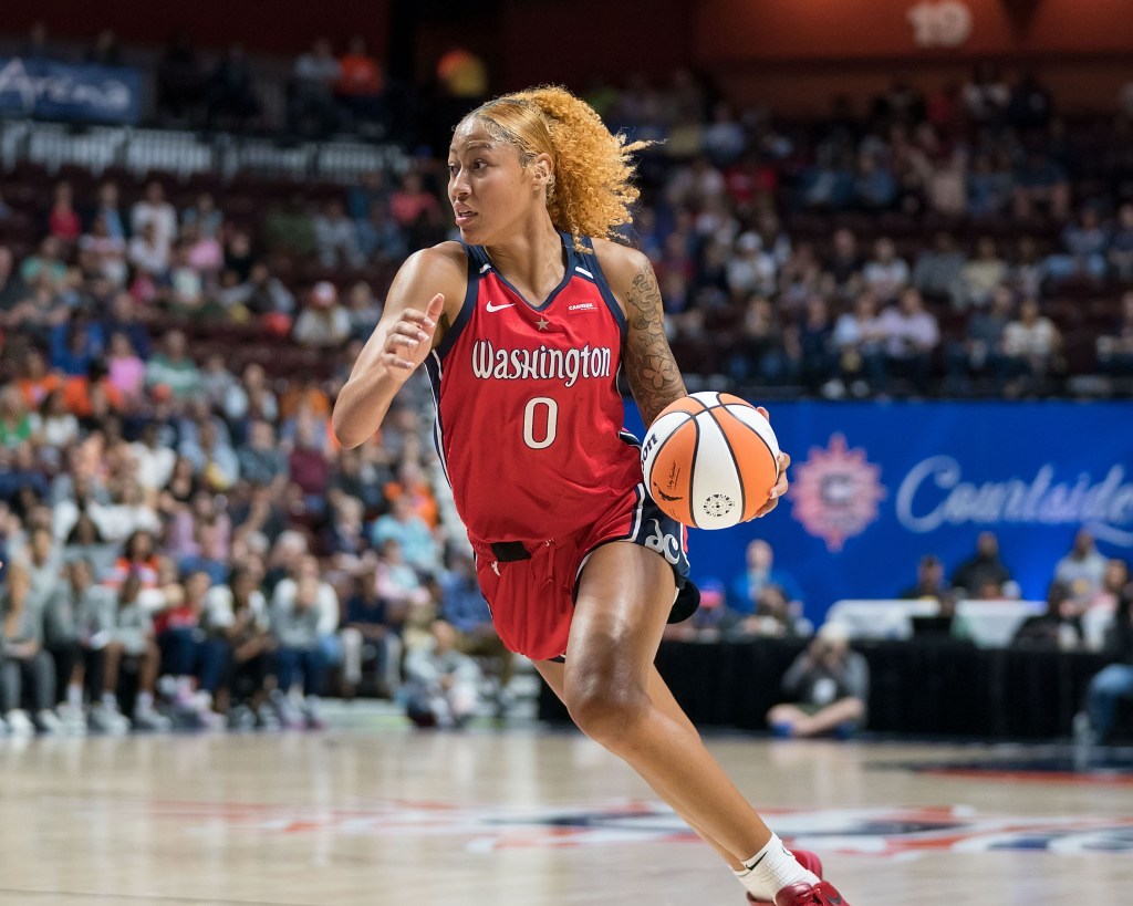 Washington Mystics center Shakira Austin dribbles the ball with her left hand. Her eyes are up and looking ahead.