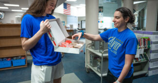 Maddy Siegrist delivers Krispy Kreme doughnuts to teachers at Carter Jr. High School in Arlington, TX. (Photo via Dallas Wings)