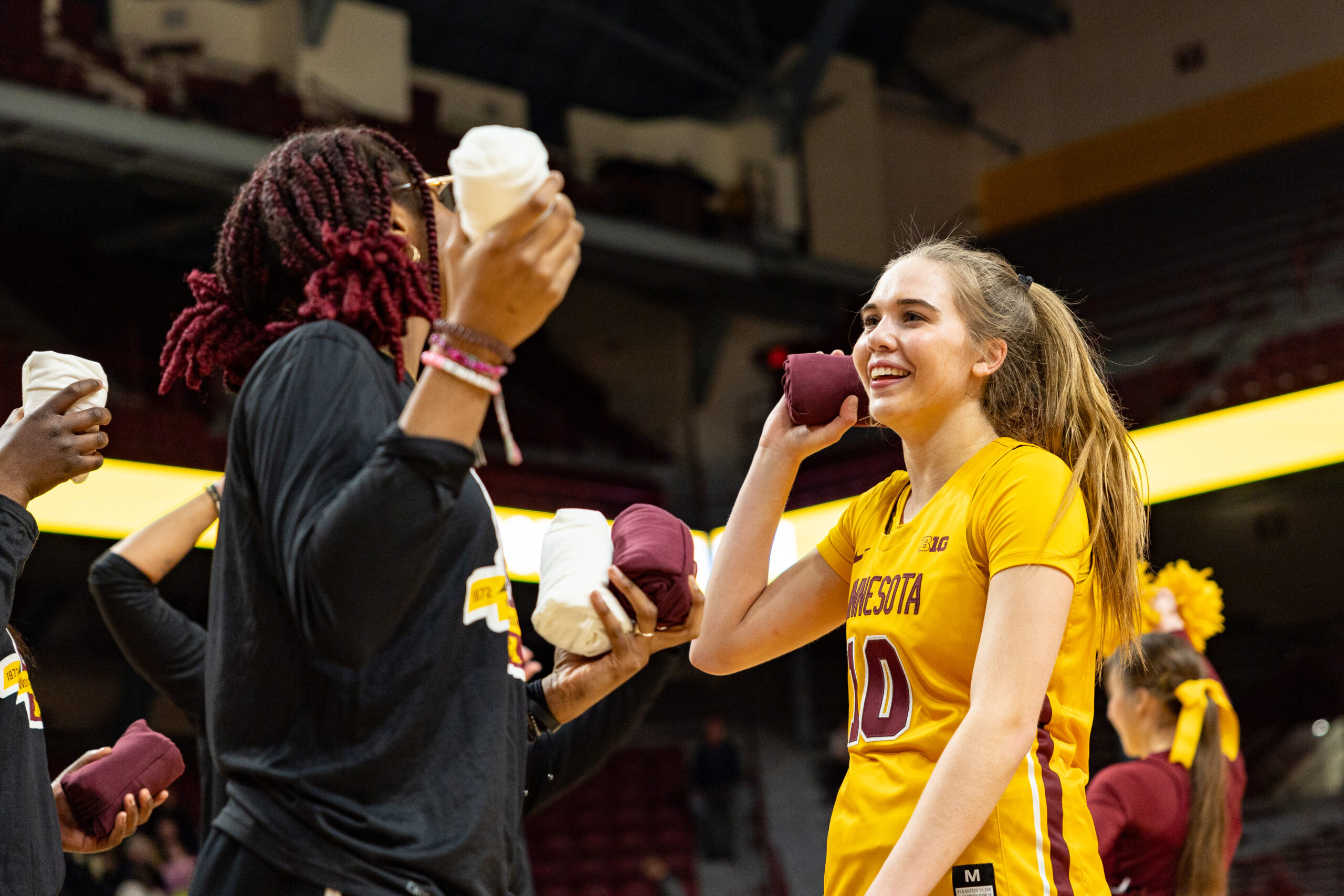 Mara Braun participates in a t-shirt toss for the Golden Gophers.