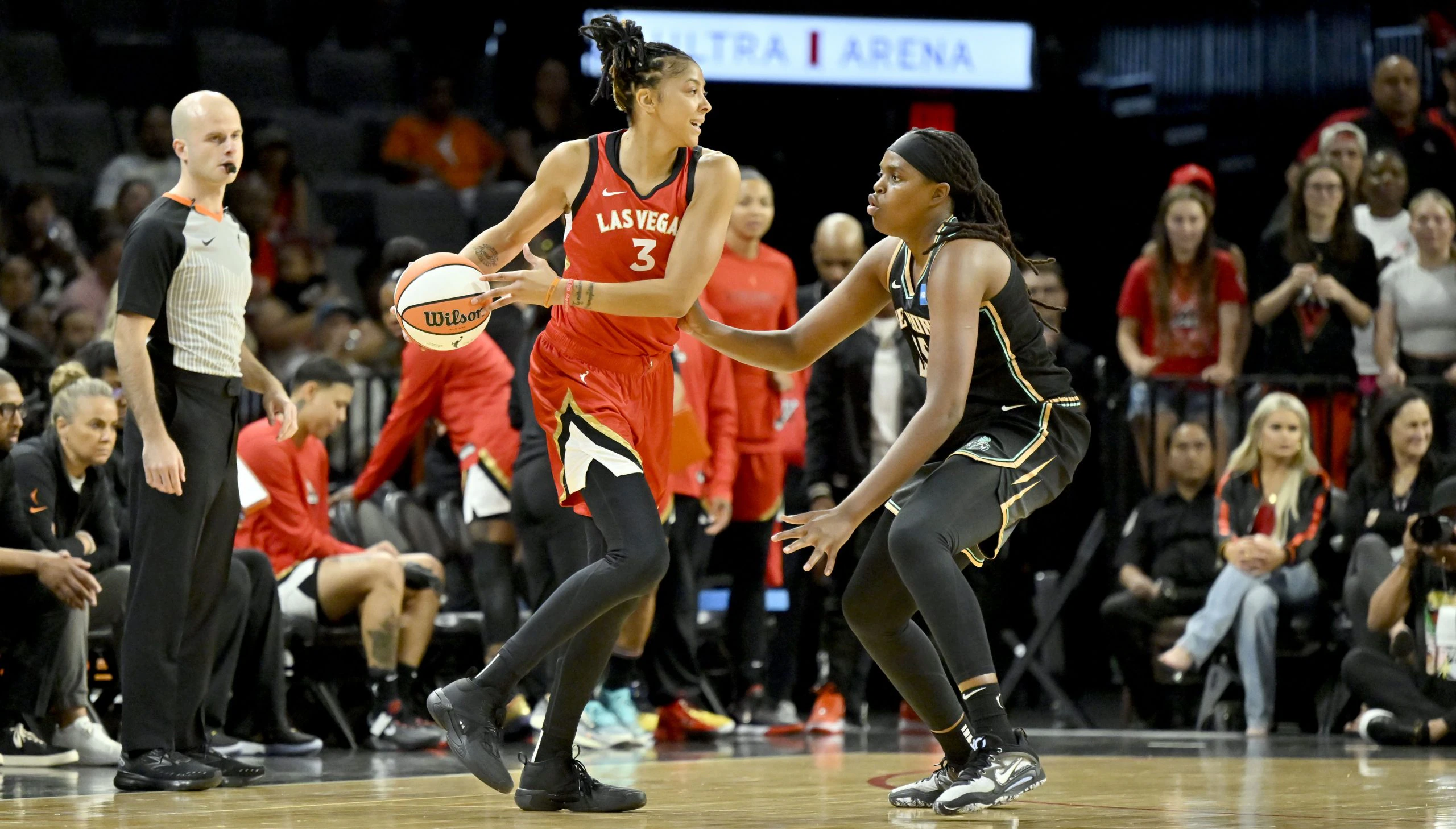 Las Vegas Aces forward Candace Parker holds the ball on the perimeter as New York Liberty forward Jonquel Jones defends during a preseason scrimmage.