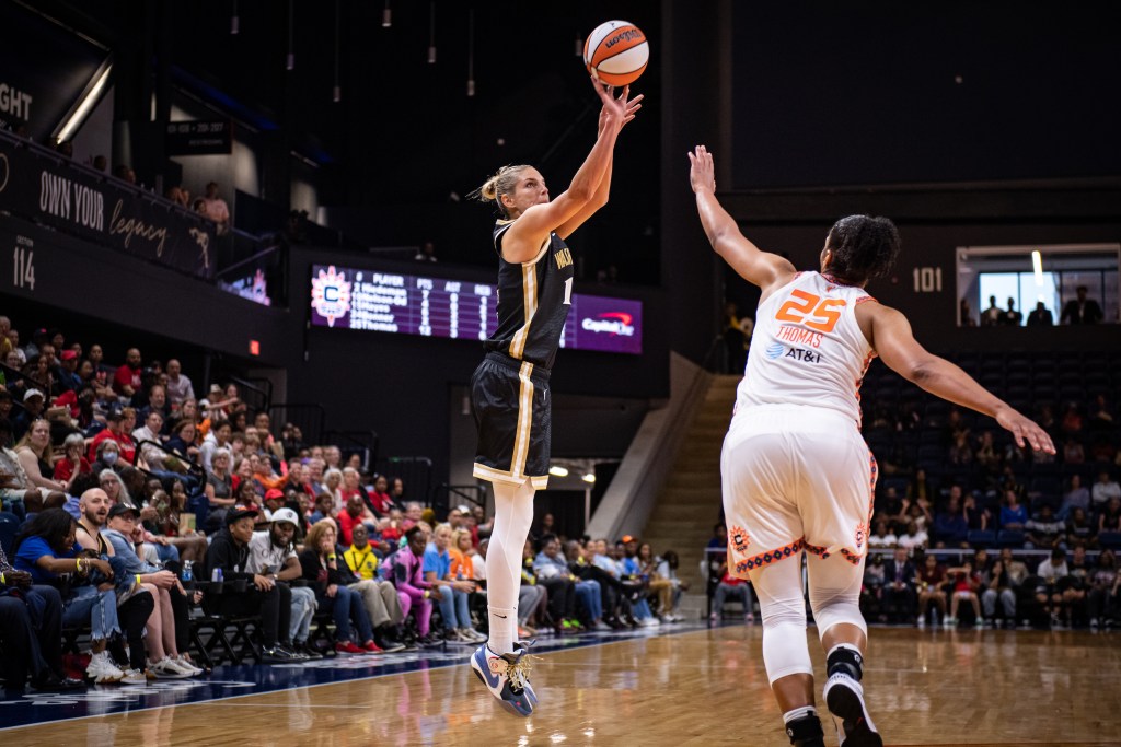 Washington Mystics forward/guard Elena Delle Donne shoots a jump shot with her right hand. Connecticut Sun forward Alyssa Thomas is late to contest the shot with her left hand.