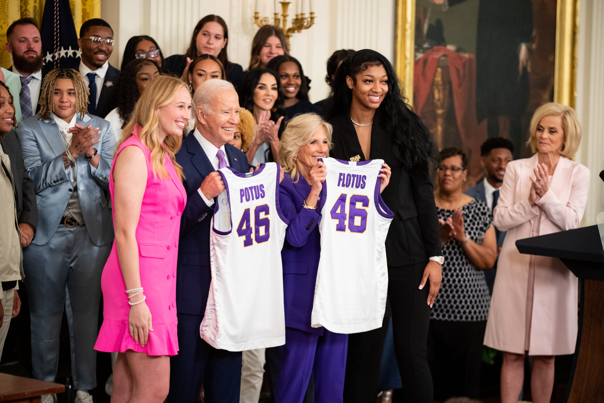 Angel Reese and Emily Ward present Jill and Joe Biden with LSU basketball jerseys during their visit to the White House.