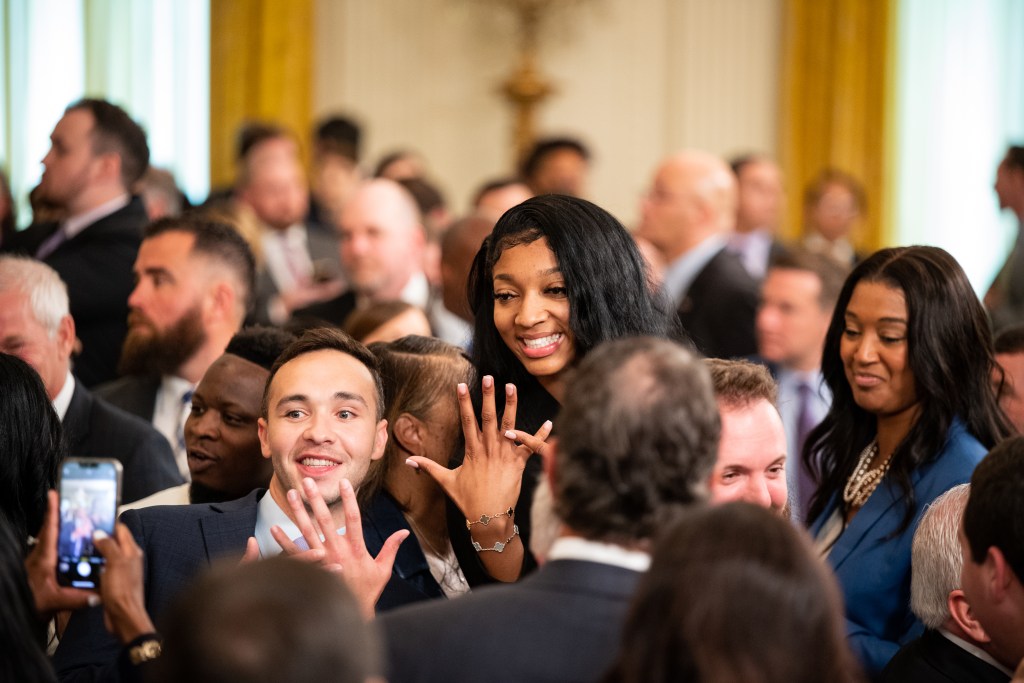 At the White House on May 26, 2023, Angel Reese poses for a photo while pointing to her ring finger, a celebration she became known for during the NCAA Tournament