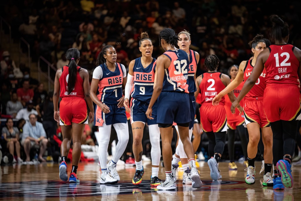 Washington Mystics guards Ariel Atkins, Natasha Cloud and Shatori Walker-Kimbrough, as well as forward/guard Elena Delle Donne, come together after a play.