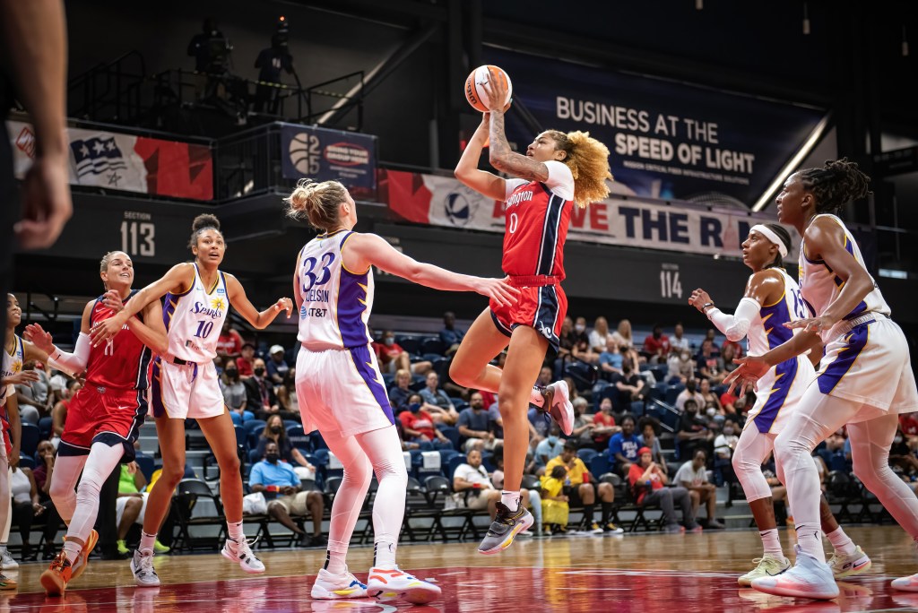 Washington Mystics center/forward Shakira Austin shoots a jump shot over Los Angeles Sparks forward Katie Lou Samuelson, whose hands are down as she helps in the lane.