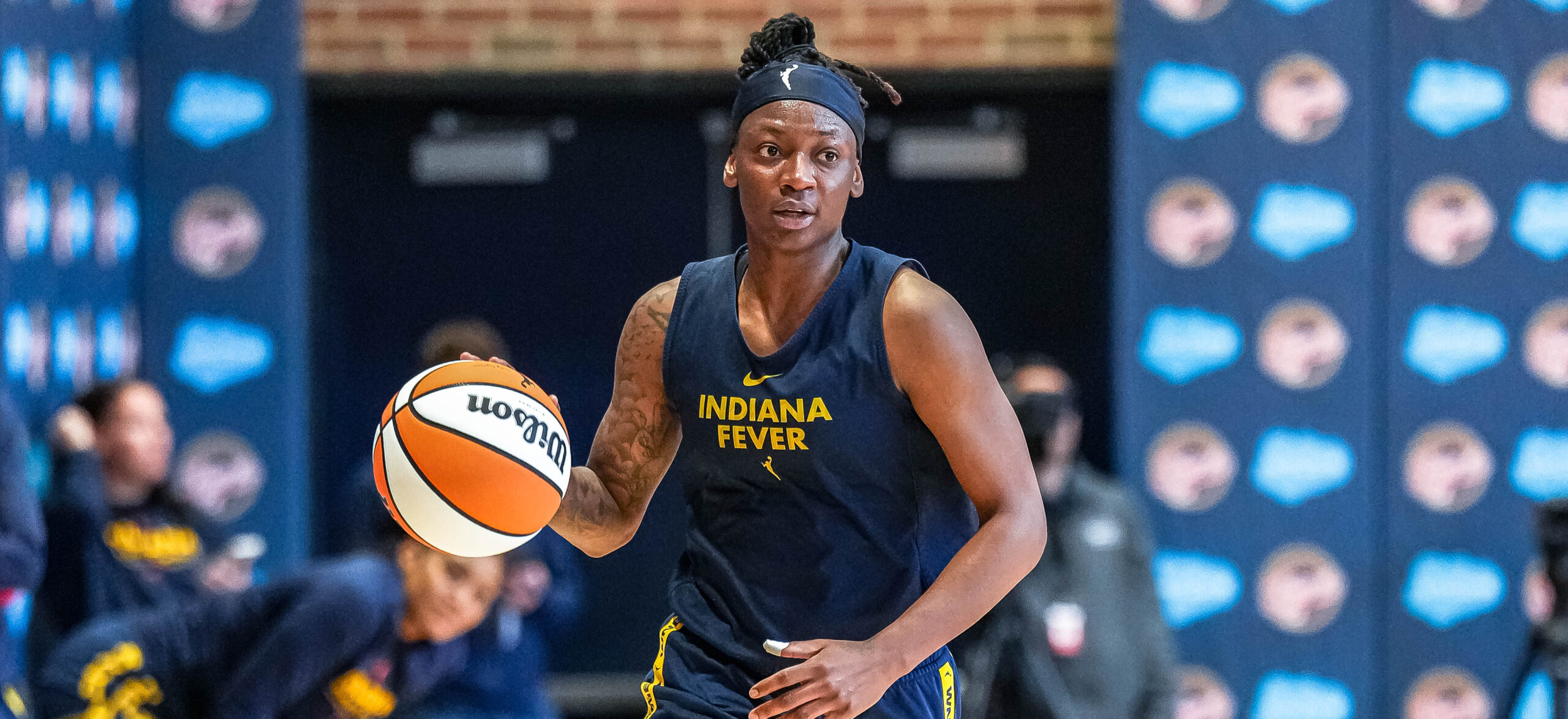 Indiana Fever point guard Erica Wheeler dribbles the ball with her right hand.