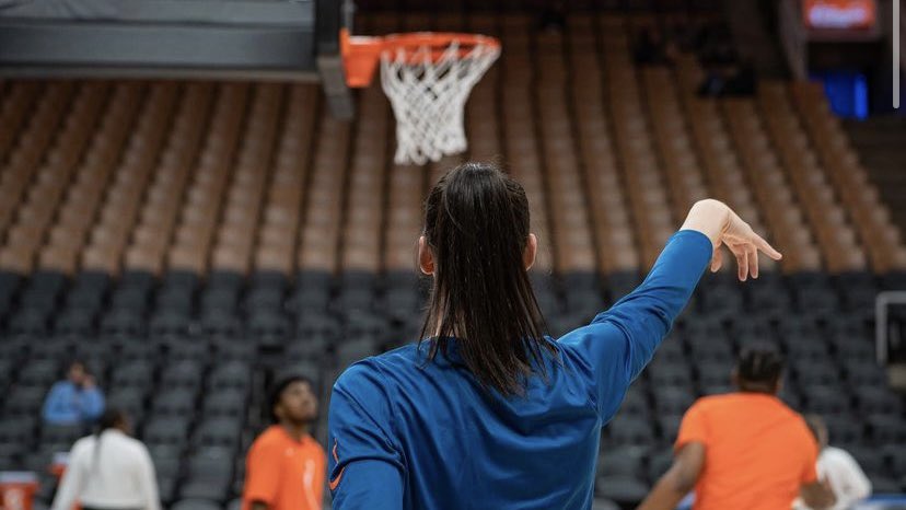 Bridget Carleton (turned away from the camera) faces the basket and follows through on a shot during pre-game warm ups at Scotiabank Arena