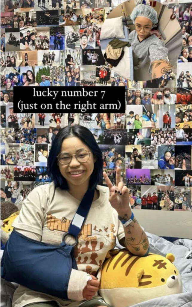Sitting on what appears to be her bed, with dozens of photos on the wall behind her, Morgan Hurd smiles and flashes a peace sign with her left hand. Her right arm is in a cast and sling.