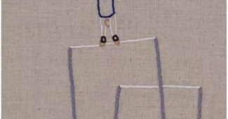 A still of an embroidered gymnast doing a handstand on the high bar.