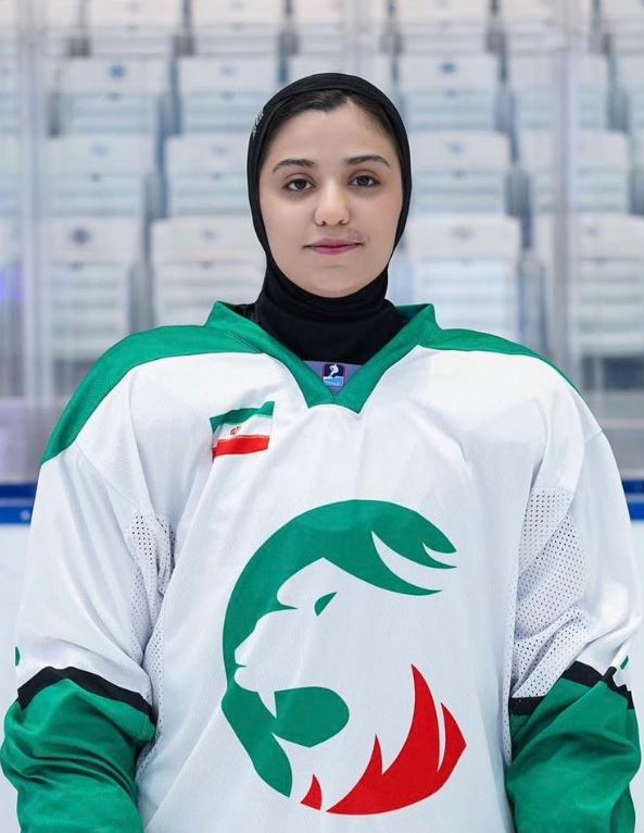 Iranian women's hockey player Fatemeh Esmaeili is pictured in a green, white and red hockey jersey.
