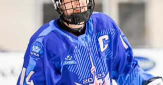 Hockey player Madison Packer is pictured in a blue and white uniform skating on the ice during practice at the 2023 PHF All-Star Game.