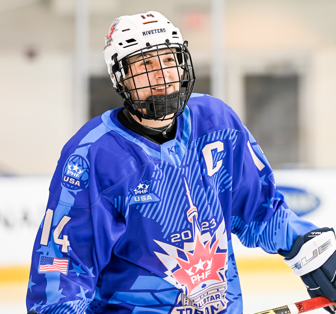 Hockey player Madison Packer is pictured in a blue and white uniform skating on the ice during practice at the 2023 PHF All-Star Game.