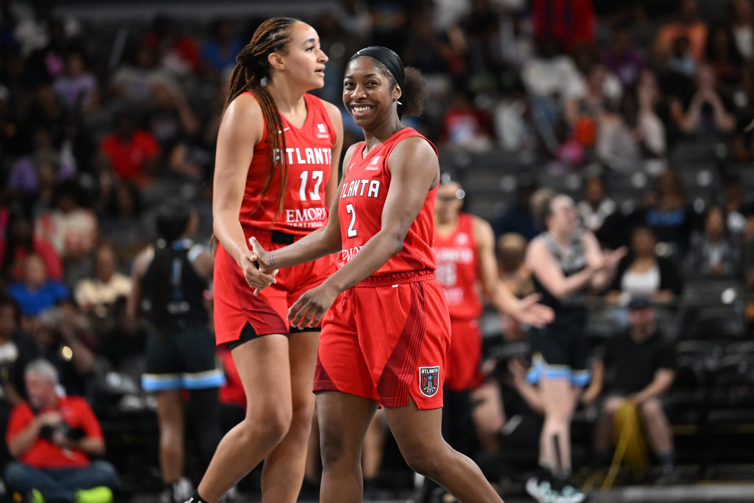 Aari McDonald and Haley Jones pictured smiling during home game vs. Chicago Sky