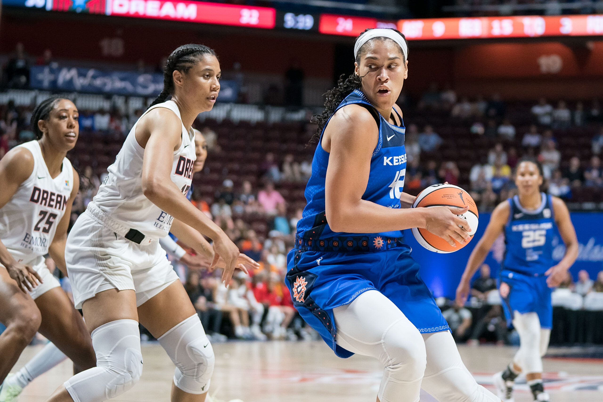 Connecticut Sun forward Brionna Jones looks to shoot as Atlanta Dream forward Nia Coffey defends