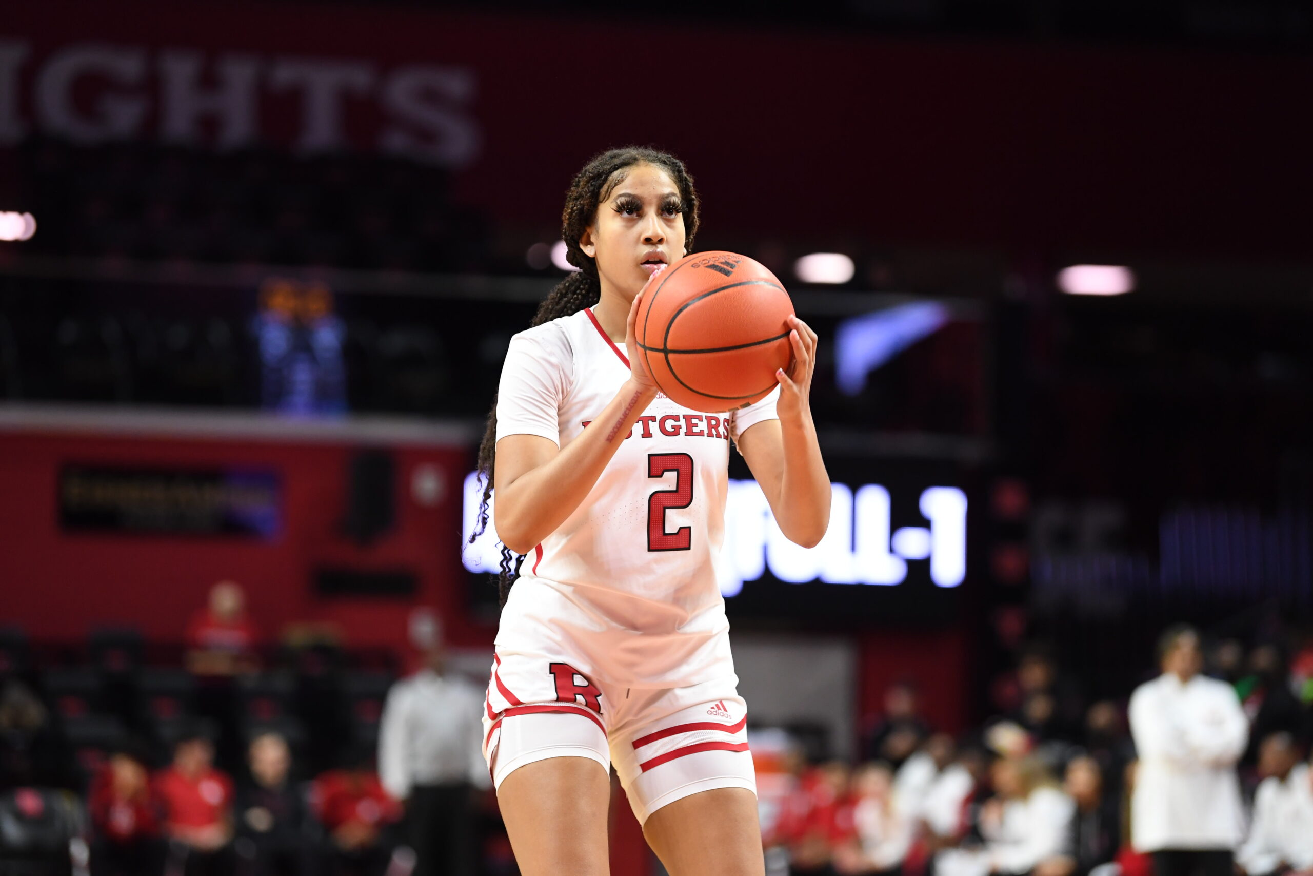Rutgers guard Kaylene Smikle stands alone, holding the ball at shoulder height and preparing to shoot.
