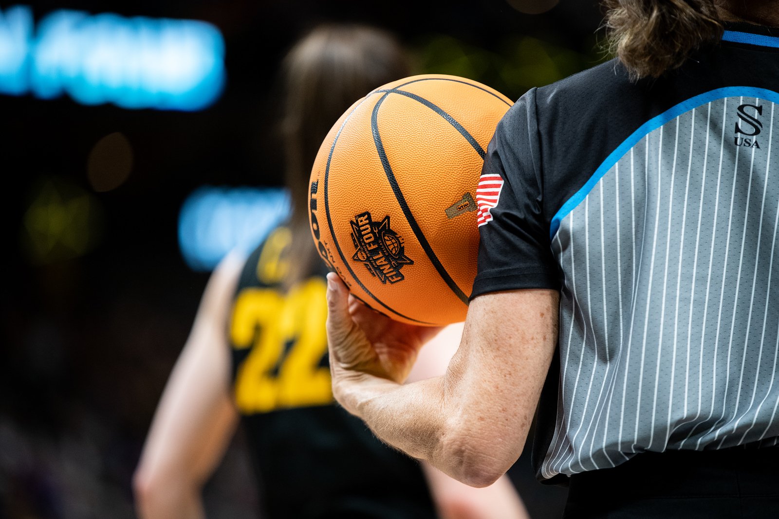 A referee holds a ball in the 2023 Final Four. (Photo credit: Domenic Allegra)