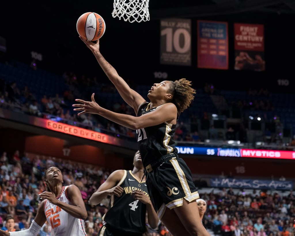 Washington Mystics forward Tianna Hawkins extends her body underneath the basket to shoot an uncontested right-handed layup.