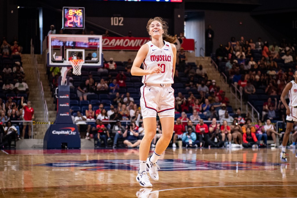 Washington Mystics guard Abby Meyers looks up and smiles on the court.