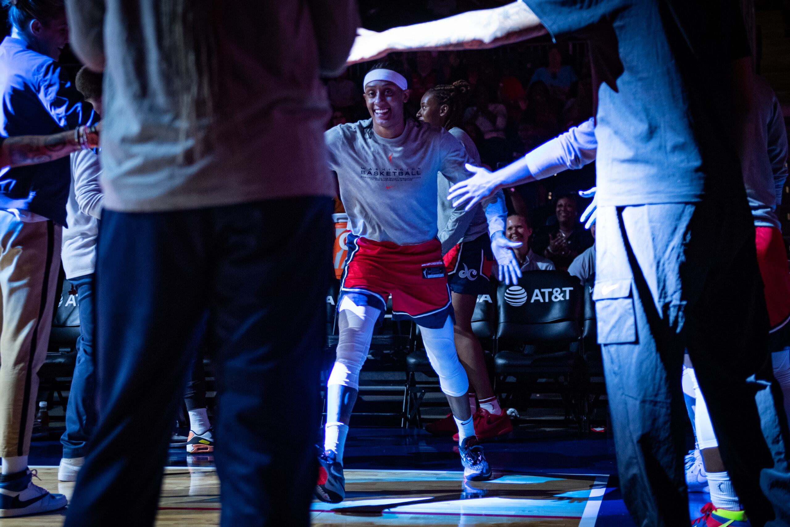 With the arena dark for pregame introductions, Washington Mystics guard Brittney Sykes smiles and high-fives her teammates as her name is called.