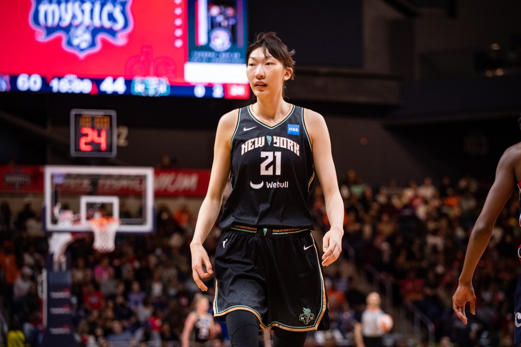 New York Liberty center Han Xu is shown in her black uniform, alone on the court.