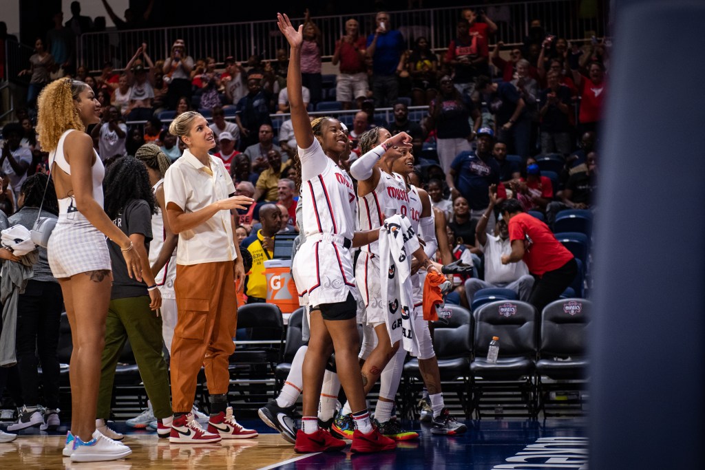 Washington Mystics guard Ariel Atkins smiles and waves to the crowd after setting the franchise record for career 3-pointers.