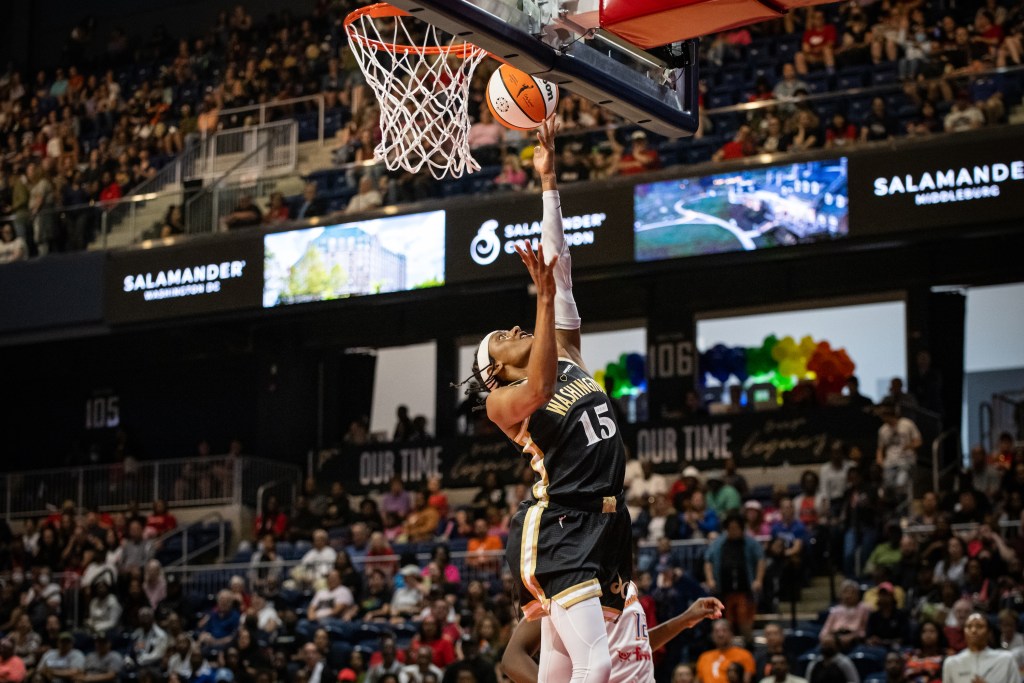 Washington Mystics guard Brittney Sykes elevates for a left-handed layup, her outstretched left hand nearly touching the backboard.