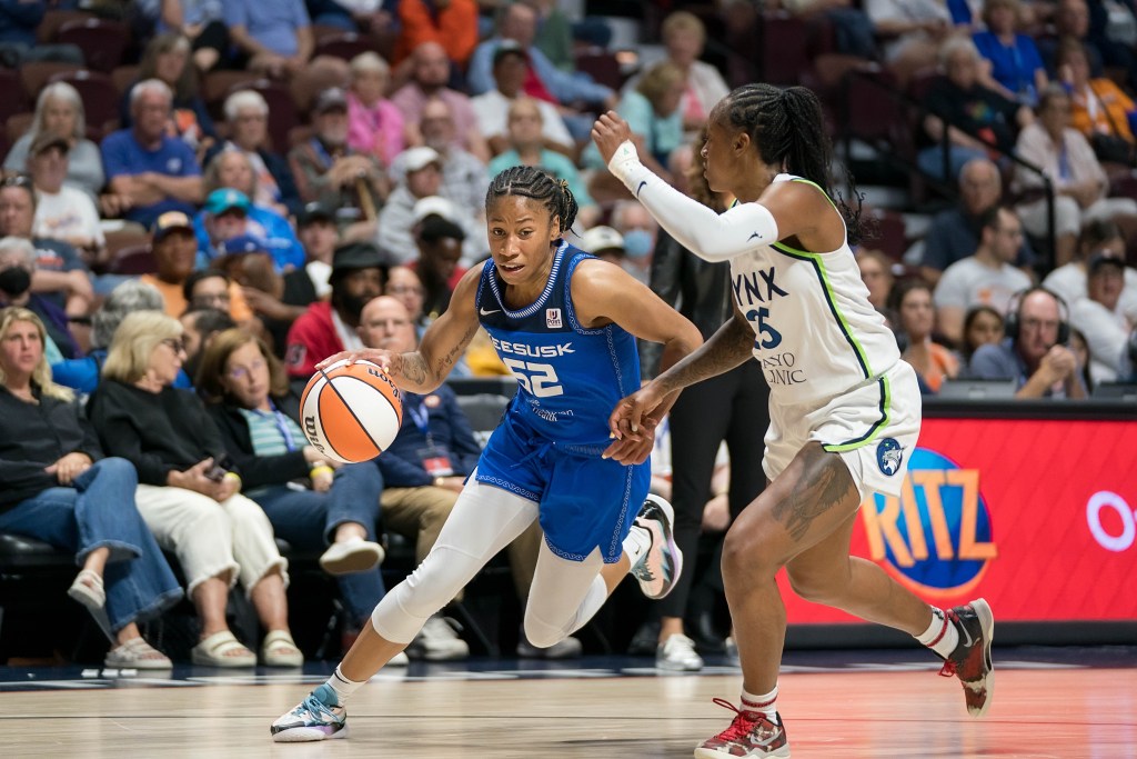 Connecticut Sun guard Tyasha Harris (52) drives at the basket as Minnesota Lynx guard Tiffany Mitchell (25) defends during the WNBA game between the Minnesota Lynx and the Connecticut Sun at Mohegan Sun Arena, Uncasville, Connecticut.