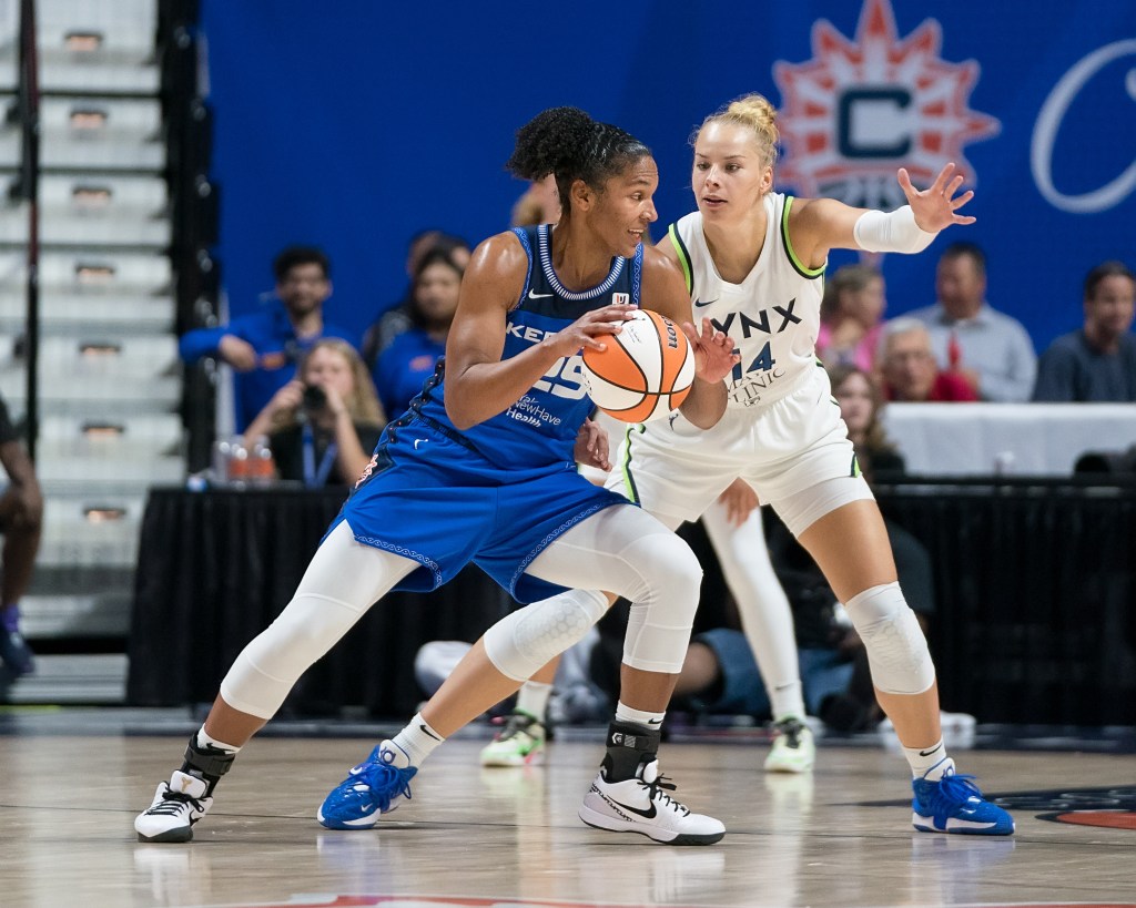 Connecticut Sun forward Alyssa Thomas (25) looks to drive around Minnesota Lynx forward Dorka Juhász (14) during the WNBA game between the Minnesota Lynx and the Connecticut Sun at Mohegan Sun Arena