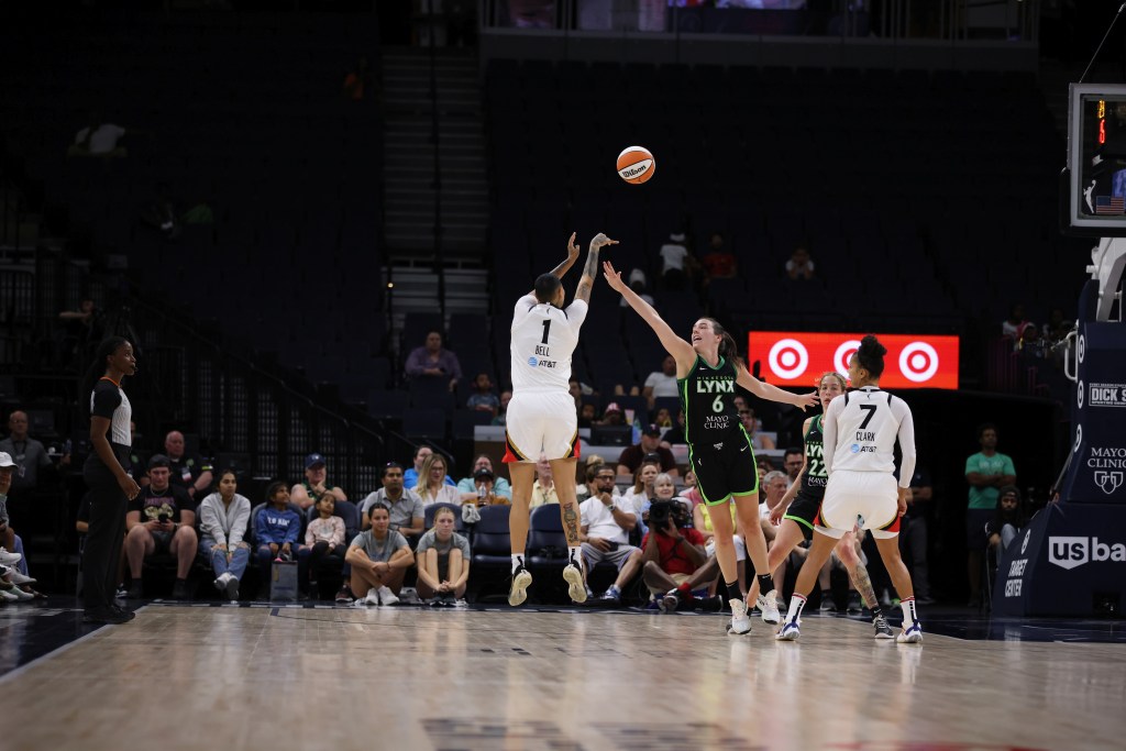Kierstan Bell shoots over the outstretched hand of Minnesota's Bridget Carleton in the Aces' July 9th game against the Lynx. 