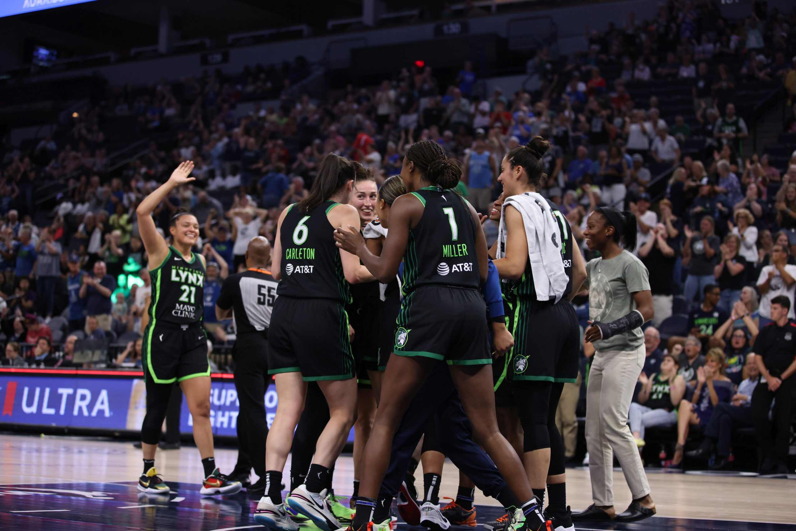 The Minnesota Lynx celebrate in a team huddle after a win.