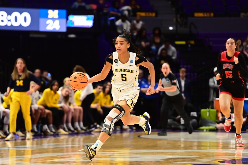 Laila Phelia dribbles the ball up the floor for Michigan.