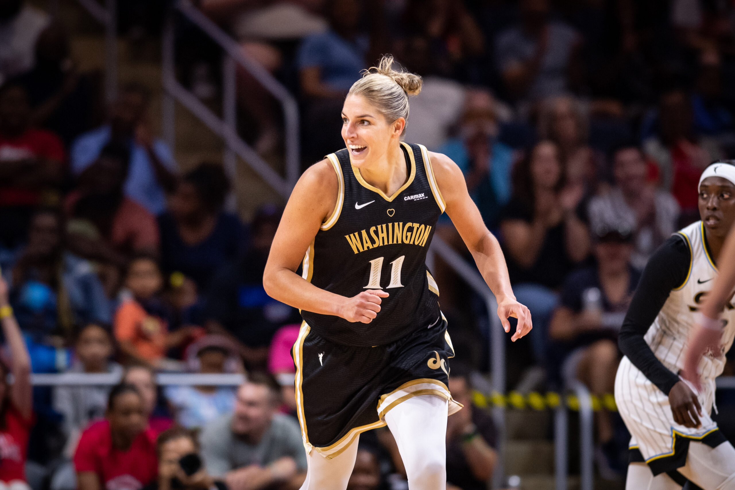 Washington Mystics forward Elena Delle Donne runs downcourt. She is looking to her right and smiling broadly.