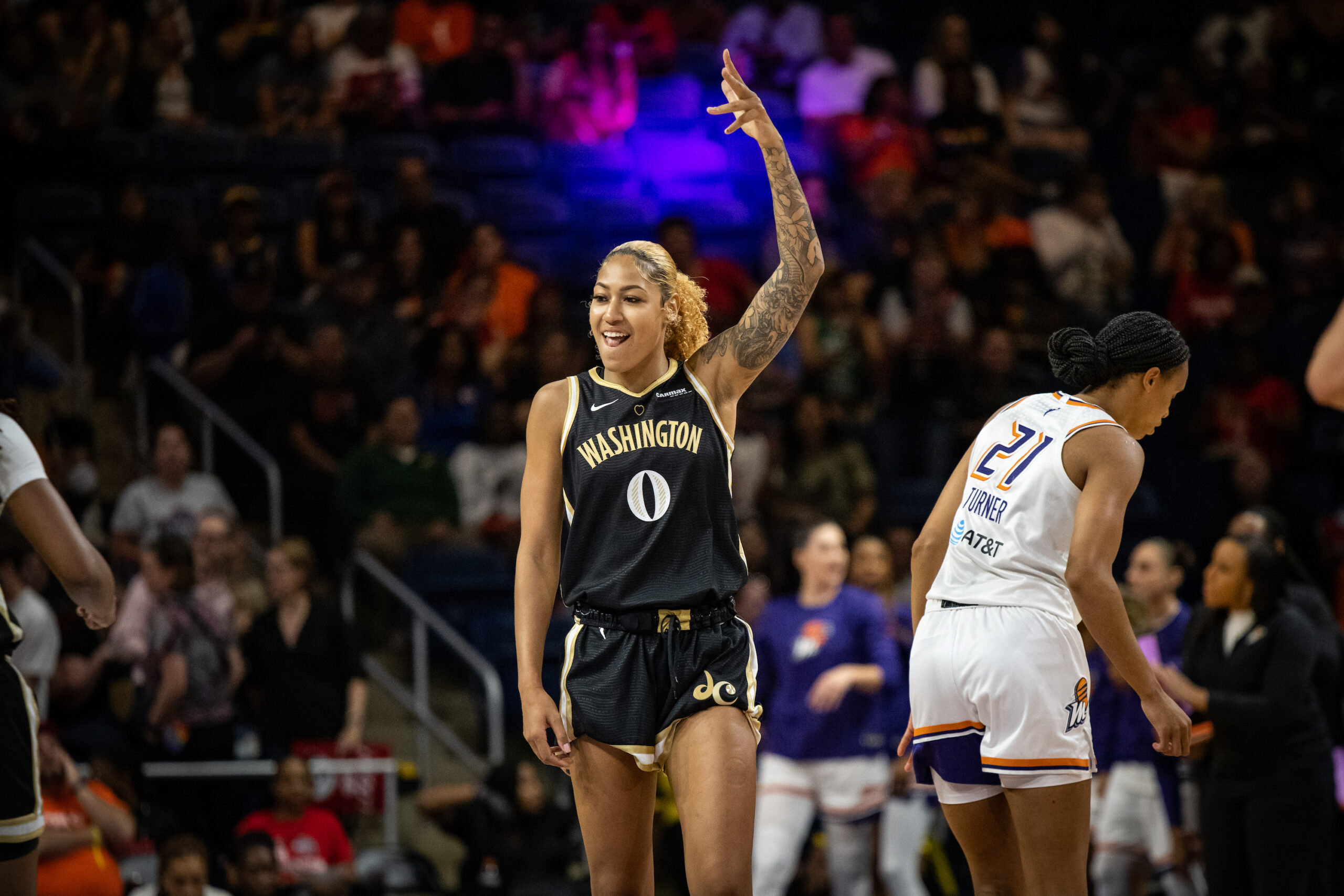 Washington Mystics center/forward Shakira Austin raises her left hand over her head and grins during a game against the Phoenix Mercury.