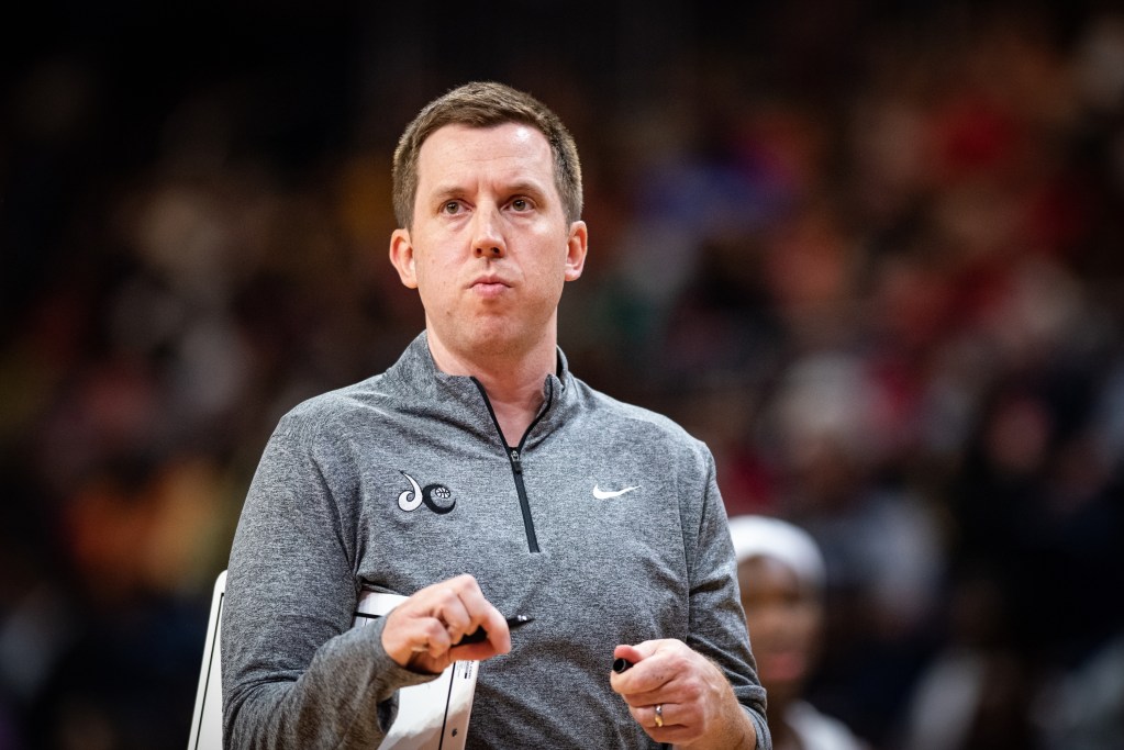 A close-up photo of Washington Mystics head coach Eric Thibault holding a marker with the cap off.