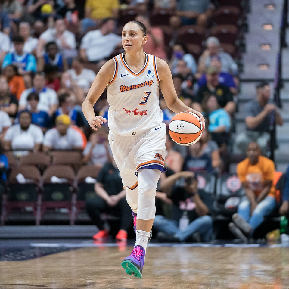 Phoenix Mercury guard Diana Taurasi dribbles the ball with her left hand and looks up court.