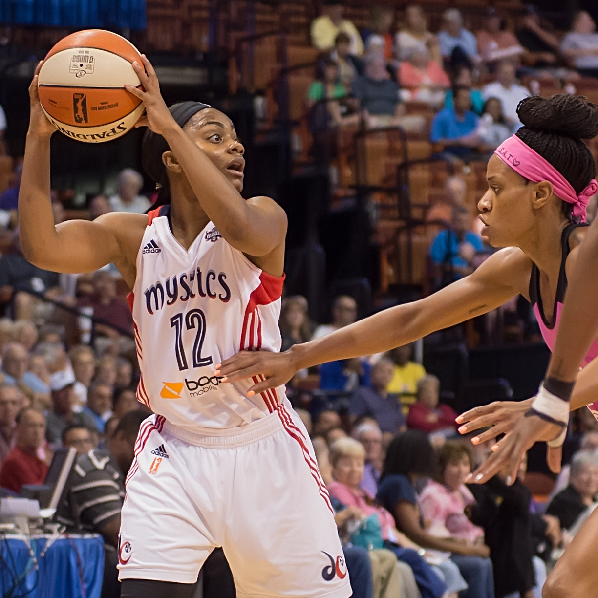 Washington's Ivory Latta (12) looks to pass during the WNBA basketball game between the Washington Mystics and the Connecticut Sun at the Mohegan Sun Arena, Uncasville, Connecticut, USA on August 07, 2015.