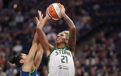 Mercedes Russell rises up to take a shot. It is heavily contested by Nikolina Milic, who has her arms straight up.