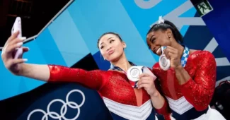 Sunisa Lee, left, and Simone Biles at the Tokyo Olympics showing off their silver medals