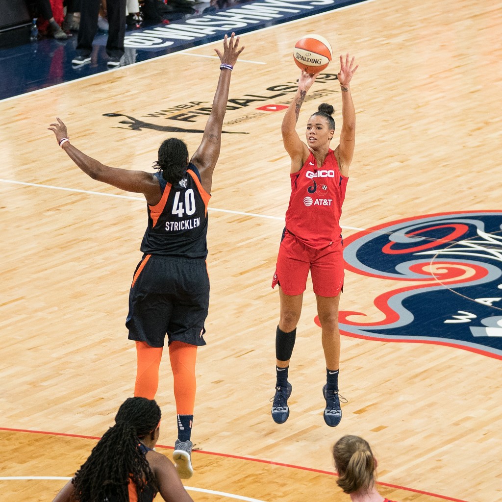 Washington Mystics guard Natasha Cloud shoots a 3-pointer as Connecticut Sun forward Shekinna Stricklen closes out with her right hand.